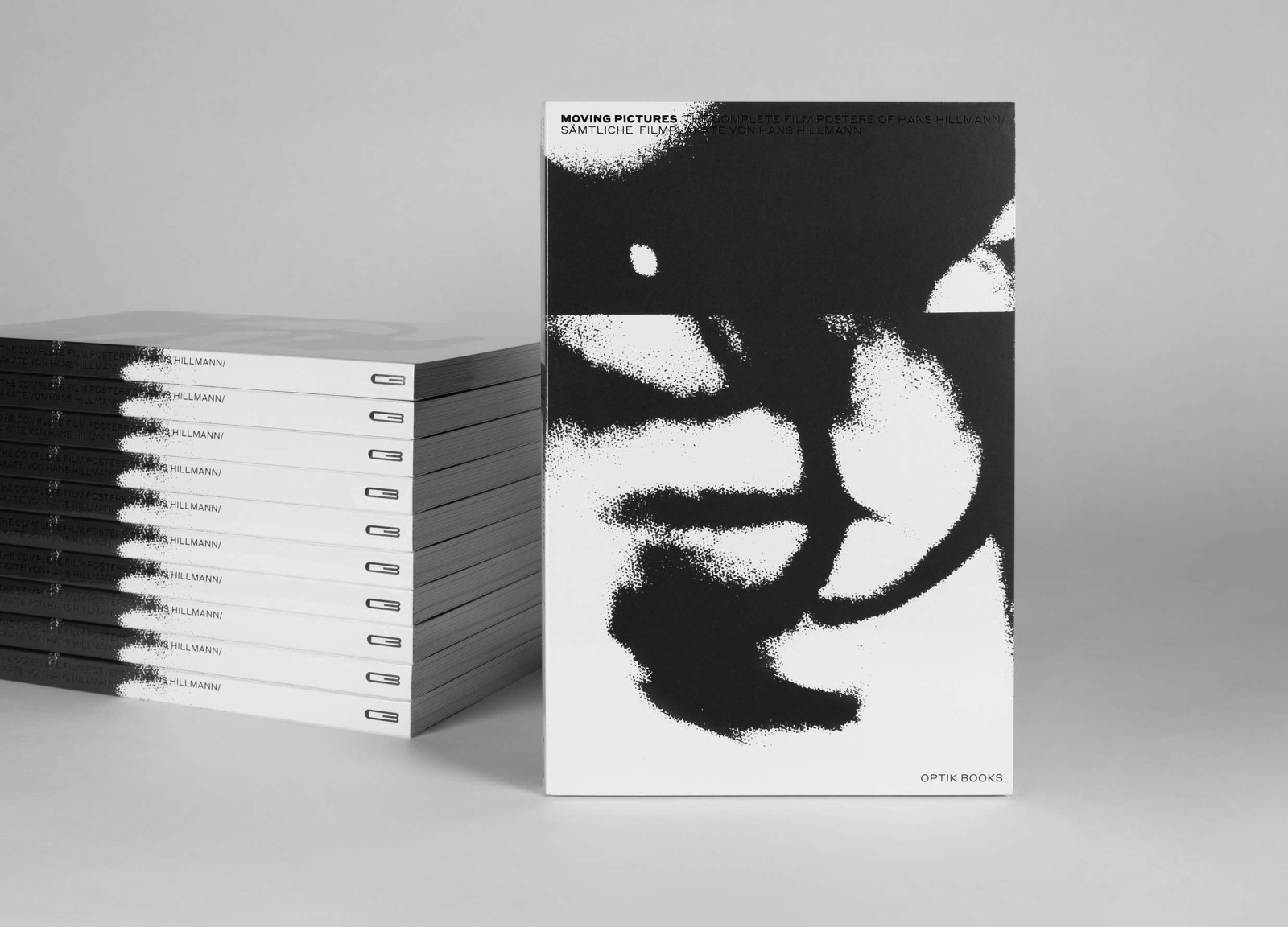 A stack of copies of the book “Moving Pictures” next to a displayed copy with an abstract black-and-white cover