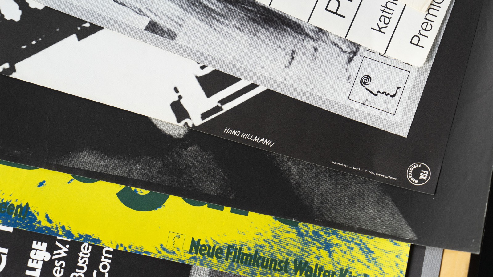 Close-up of a stack of Hans Hillmann posters, including “Neue Filmkunst” and a signed copy